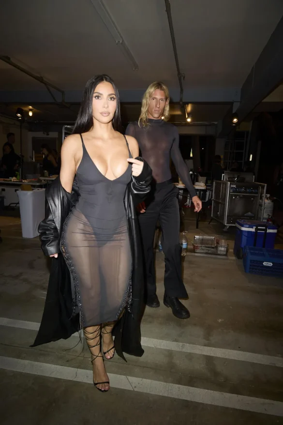 kim kardashian in a sheer black dress and leather coat leaves the update pop up on melrose 10