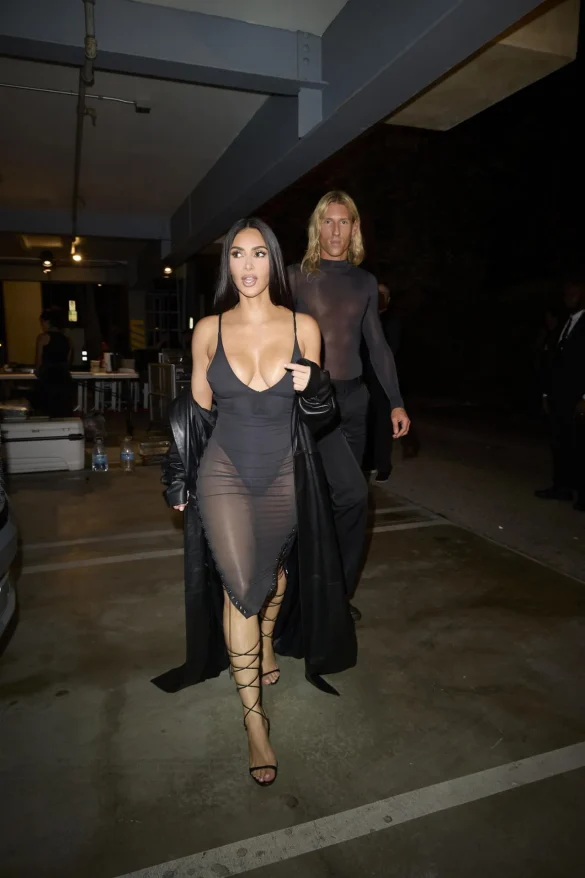 kim kardashian in a sheer black dress and leather coat leaves the update pop up on melrose 5
