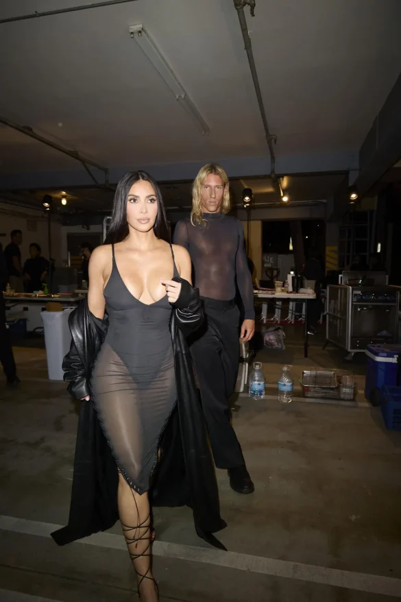 kim kardashian in a sheer black dress and leather coat leaves the update pop up on melrose 6