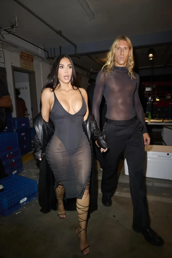 kim kardashian in a sheer black dress and leather coat leaves the update pop up on melrose 8